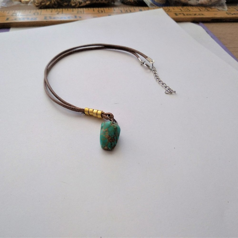 Gold striped Touquoise stone with brown rope adjustable chain.